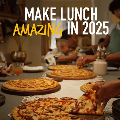 Make lunch amazing in 2025. Family at table eating pizza