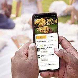 Person holding a phone with online ordering app